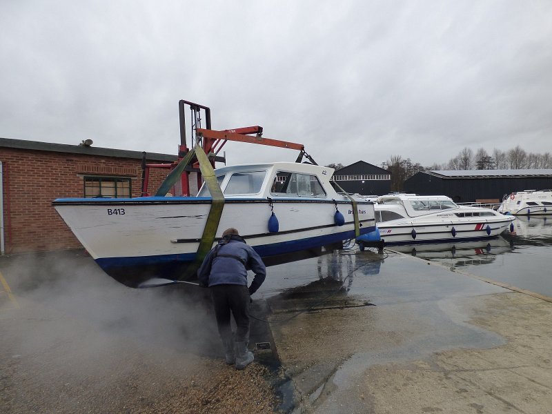 day boat being lifted above the yard