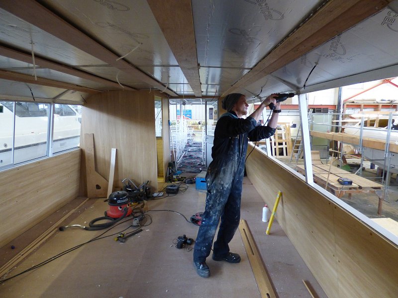 internal shot of man working on window frames of queen of the broads