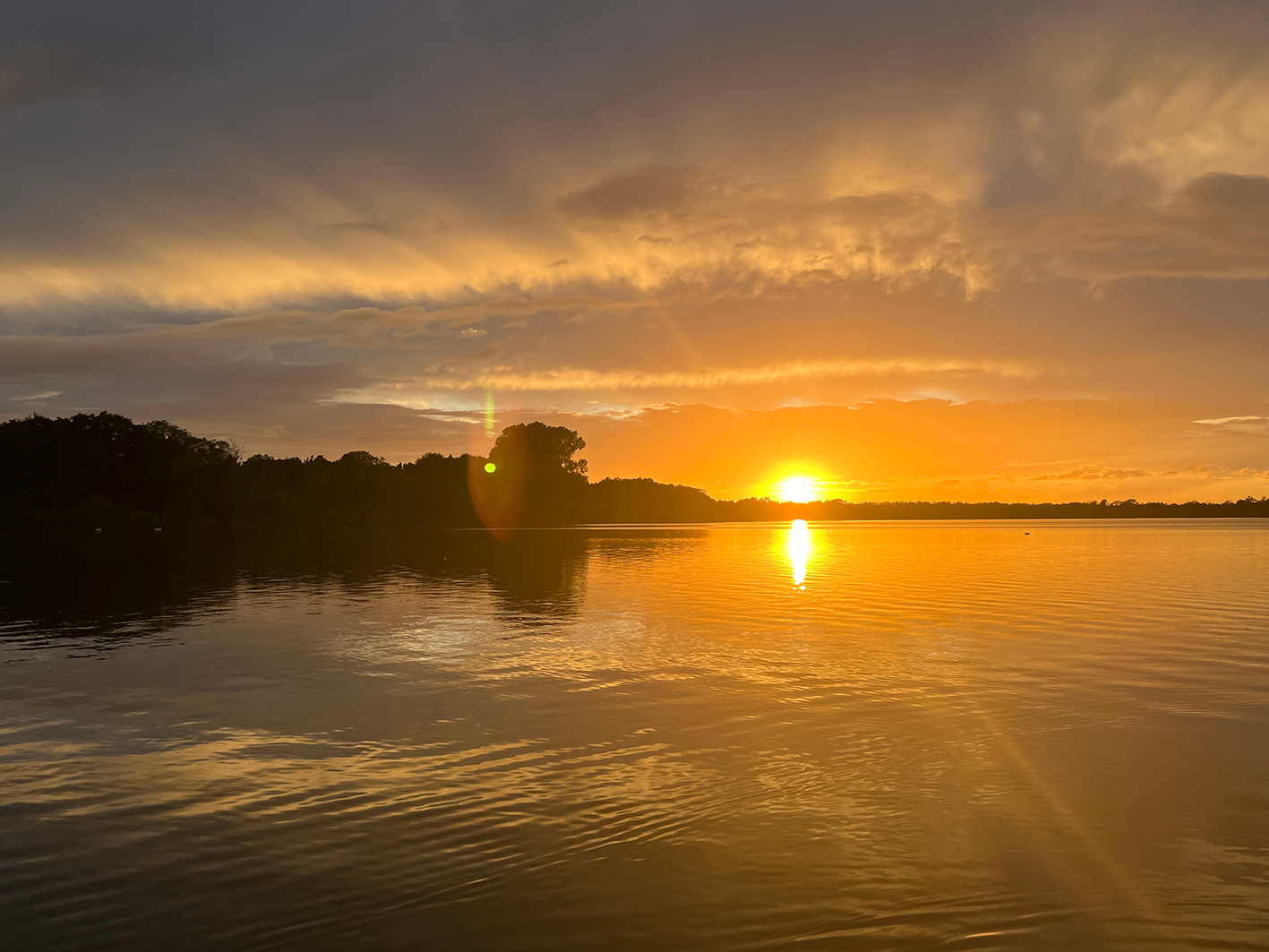 Summer sunset landscape sun setting over Norfolk Broads England
